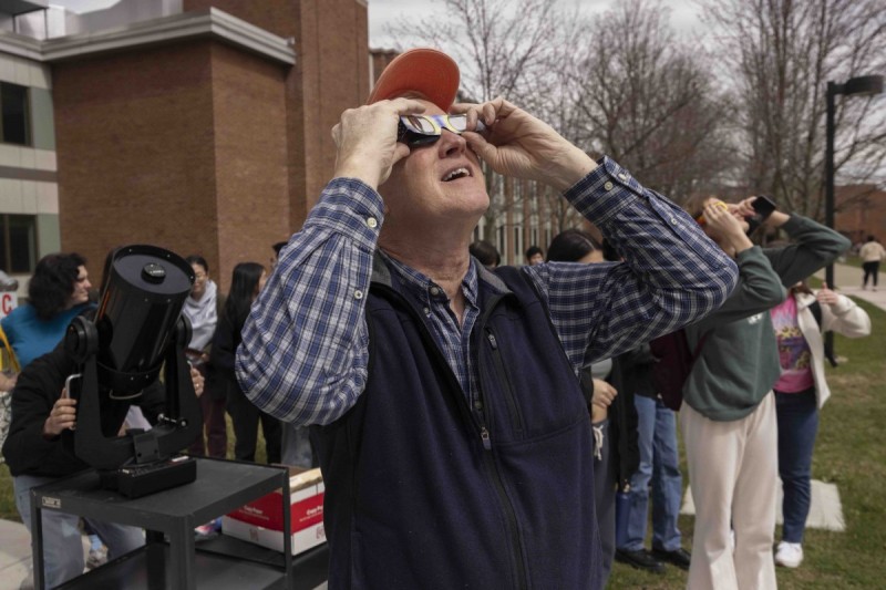 Mark Stephens, an instructional support specialist with the Physics Department, looks at the unfolding solar eclipse in the Science II courtyard.