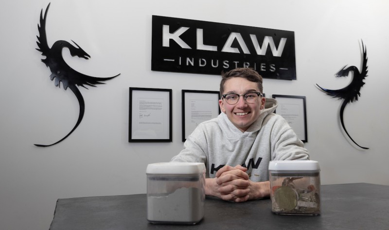 Jacob Kumpon ’22, is the chief operating officer of KLAW Industries in Binghamton. In the containers are, at left, processed Pantheon and, at right, unprocessed recycling waste.