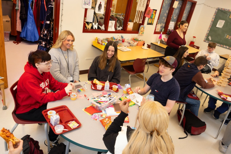 Expanding mental health services and making them available in schools is a key initiative of the UACS model at Whitney Point. Social work intern Avery Burnsworth, second from left, meets with students at Whitney Point High School.