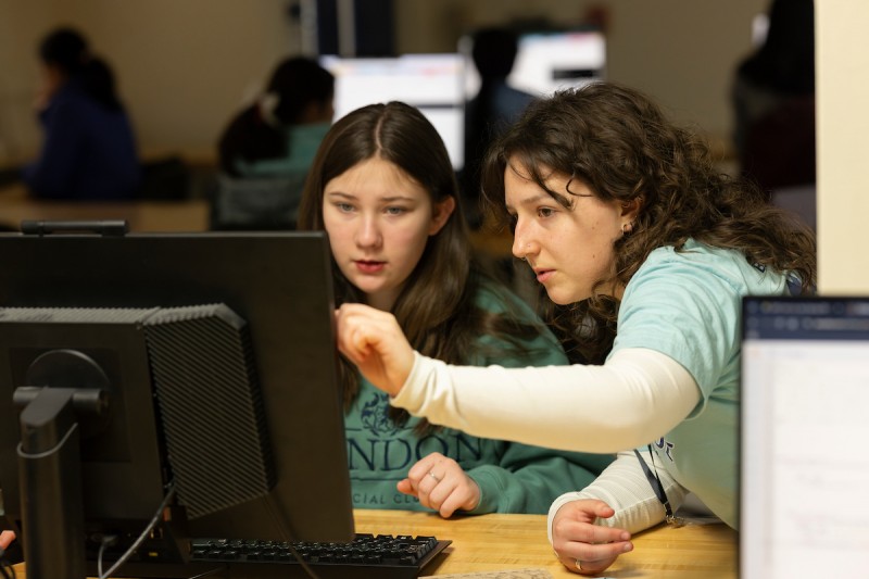 Girls Who Code instructor Laura Cunningham ’24, right, helps 12-year-old student Laney Bubel from Apalachin, N.Y., during a GWC class.
