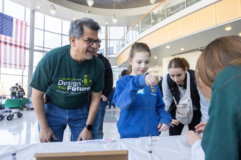 Watson College Dean Atul Kelkar spent time with visitors during Community Day in February, organized for local youths as part of Engineers Week.