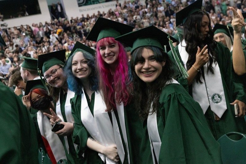 Harpur College graduates strike a pose during the first Commencement ceremony on May 17, 2025.