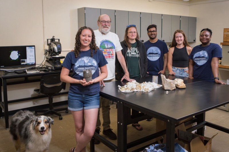 Assistant Professor Adriane Lam, Professor Howard Richard Naslund and Associate Professor Molly Patterson and graduate students Ravi Kiran Koorapati, Halima Ibrahim and Gretl King have all participated in expeditions with the International Ocean Discovery Program (IODP) or its successor organization, the International Ocean Drilling Program (IODP³). Photograph taken at Lam's Science 1 laboratory, July 24, 2025, including Lam's Australian Shepherd Katie.