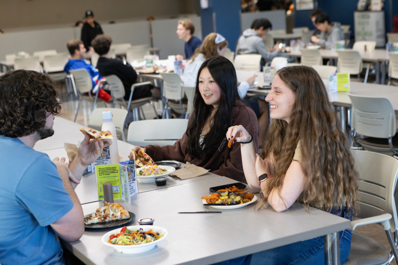Undergraduate Raya Sitman eats dinner with friends at the Chenango Champlain Collegiate Center.