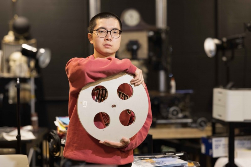 Cinema major Sota Oba ’27 holds a film reel.