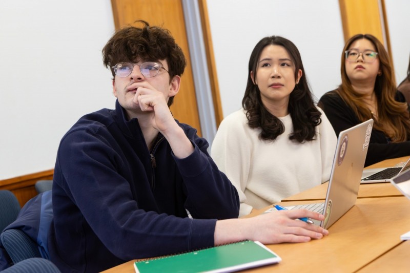 From left, students Trevor Grimes, Cynthia Chen and Kristen Li listen as Associate Professor of History Wendy Wall discusses an ongoing research project into racial covenants in Broome County.