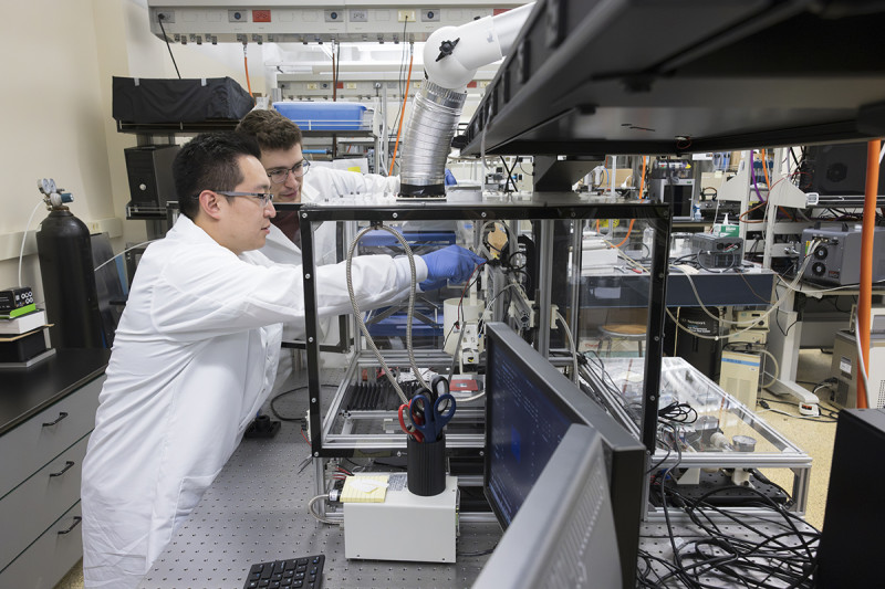 Union-Endicott High School teacher Andrew Genussa '18, MAT '19, left, works on thin film deposition with mechanical engineering master's student Daniel Szlavik in Professor Paul Chiarot's lab at Binghamton University's Innovative Technologies Complex. Genussa was part of the Research Experiences for Teachers program.