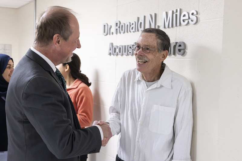 Watson College Senior Associate Dean Peter J. Partell congratulates Distinguished Professor Ronald Miles at the dedication of the Ronald N. Miles Acoustics Core at Binghamton University's Engineering and Science Building on Monday, Sept. 28.