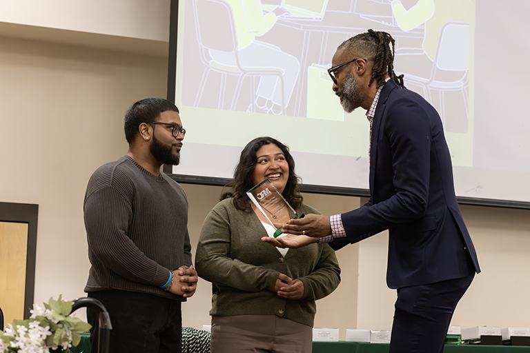 MRC Assistant Director Marc-Leonce Volcy presents the Multicultural Pre-Professional Organization Award to ColorStack.