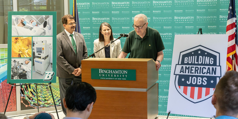 From left, Watson College of Engineering and Applied Science Dean Atul Kelkar, Binghamton University President Anne D’Alleva, and  U.S. Sen. Chuck Schumer at a ribbon-cutting ceremony for a new state-of-the-art cleanroom and microelectronic packaging research facility at the University's Innovative Technologies Complex Thursday, July 2, 2026. Aided by $1 million in federal funding secured by Schumer, the facility will help students learn the fundamentals of the semiconductor manufacturing process and prepare a workforce to fill critical microelectronics manufacturing jobs.