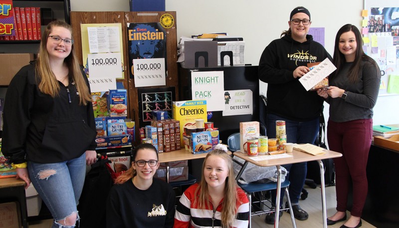 Alexis Green (far right) and other student-volunteers celebrate Knight Pack raising its 100,000th food item in 2019! By spring 2023, Knight Pack had exceeded 275,000 food items provided to those in need.