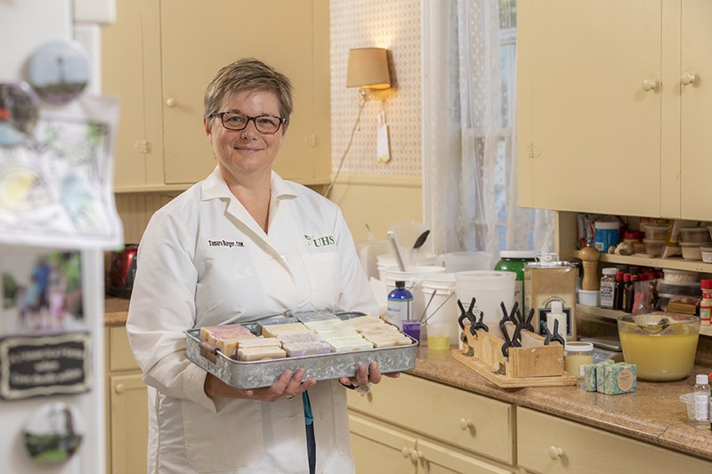 Tammy Burger, a clinical instructor at the Decker College of Nursing and Health Sciences, shows some of the soaps she makes at her Binghamton home.