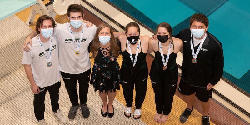 David Walters, second from left, and Sophia Howard, third from right, took first place in both 1- and 3-meter events at the America East Diving Championships, April 17-18. Erik Temple, left, and Ryan Cohn also medaled in both events, marking the first time in the team's history to sweep all medalist honors at an AE championship. Lindsey Weissman, second from right, took third in the 3-meter event. Head diving coach Heather Colby is third from left.