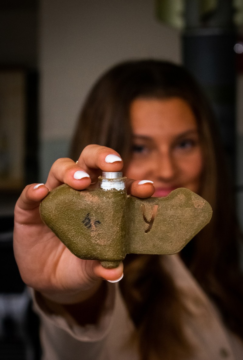 Geophysics major Madison Tuohy holds an inert PFM-1 anti personnel landmine. She has researched landmine detection techniques using drones.