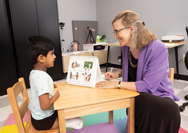 Dawna Duff, associate professor of speech and language pathology, works with 6-year-old Arnav Sundeep at Decker College’s Health Sciences Building.