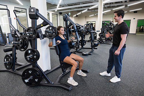 Evan Goldberg and Imani Colon-Solivan, both graduate students in the School of Management, work out in the new FitSpace.