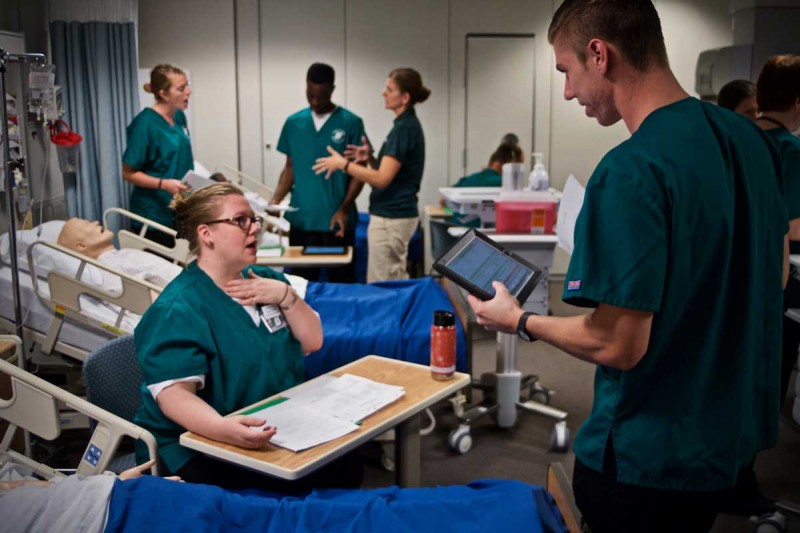 Patti Reuther and Patrick Leiby of the Decker School of Nursing Innovative Simulation and Practice Center developed their own Electronic Health Record system for use in student simulations. The student in the foreground is using the system on an iPad.