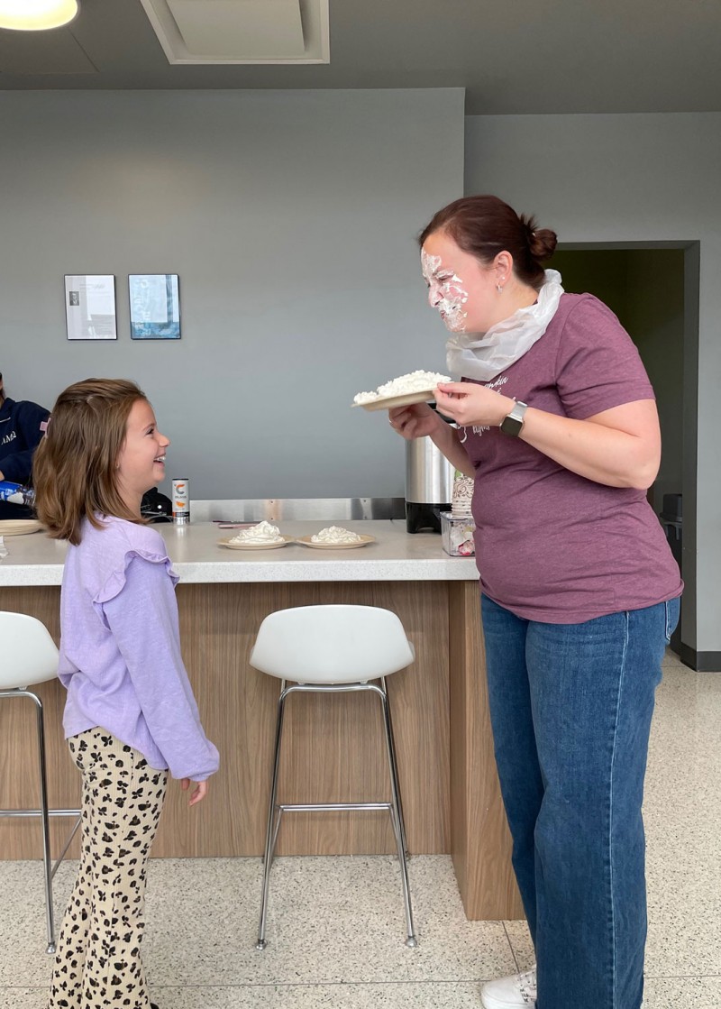 Clinical Associate Professor of Pharmacy Practice Erin Pauling and her daughter Eliza laugh together after their fun moment at the fundraiser.
