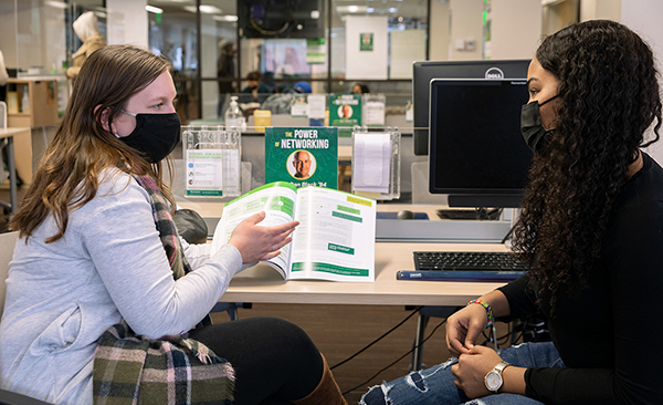Emily Ziemba, left, a graduate assistant at the Fleishman Center for Career and Professional Development, works with English major Zaliyah Vernon at the center in February 2022.