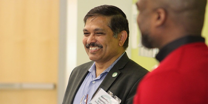 Dean Nagaraju looks on as members of Hackensack Meridian Health get a tour of the pharmacy school