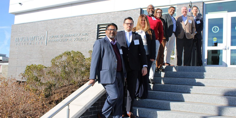 Members from both Hackensack and Binghamton pose in front of the pharmacy school following the tour