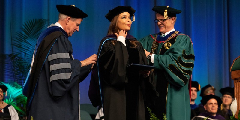Four individuals will receive honorary doctorates at Binghamton University’s 2024 Commencement ceremonies, May 9-11. Here, University President Harvey Stenger and former Provost Donald Nieman confer an honorary Doctor of Laws degree to Asuncion Cummings Hostin ’90 in 2018.