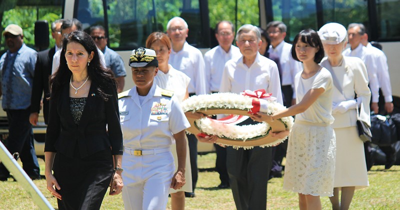 Left: Hyatt walks with Japanese Emperor Akihito before he lays a wreath at a
memorial site in Peleliu, Palau, where U.S. service members died in World War II.