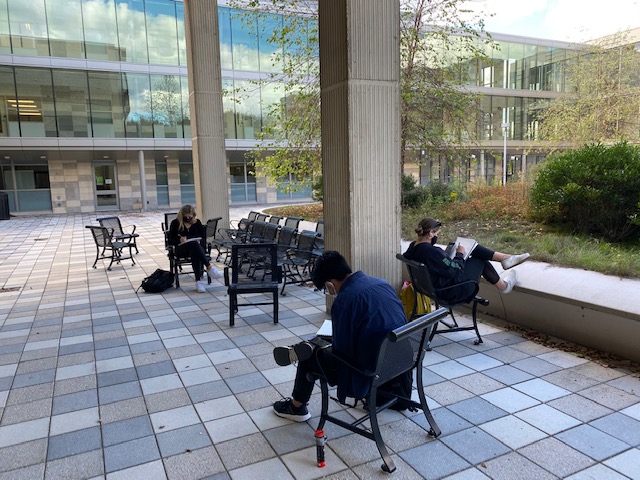 Members of Alexandra Davis' drawing class work on an assignment outdoors.