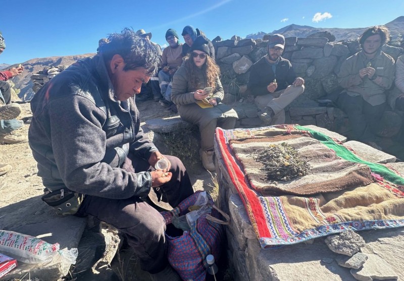 A shaman performs a ceremony before the excavation begins on a former fortified hilltop outside the town of Achoma in Peru.