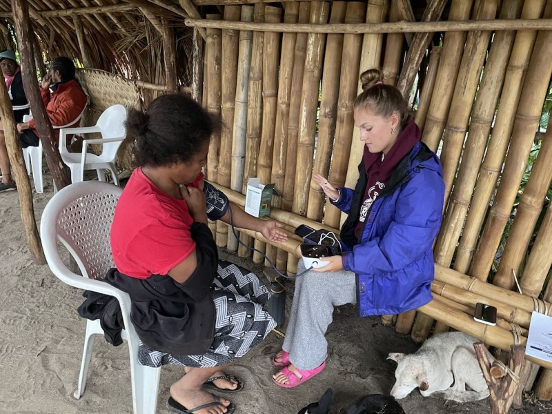 Olivia LaSalle, a student who took part in the Vanuatu Health Transition Project, examines a participant.