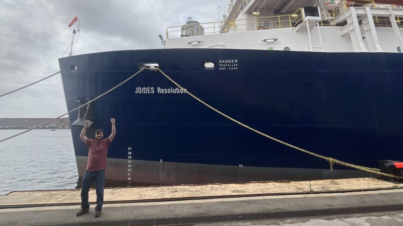 Michael Kashinsky, a junior geological sciences major, stands next to the JOIDES Resolution, a deep-sea research vessel.