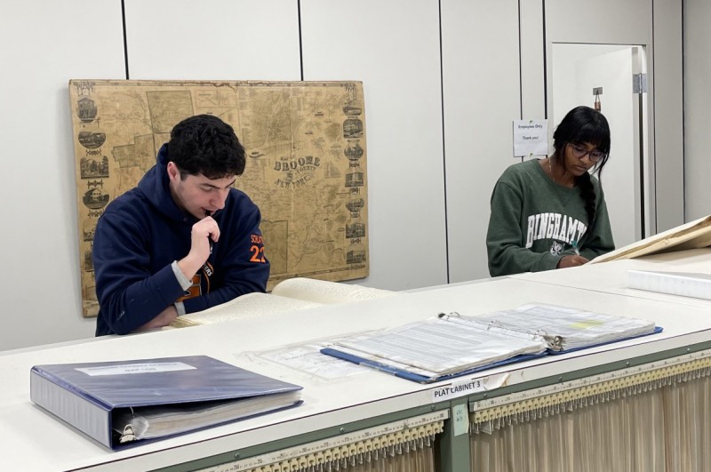 Students in Associate Professor of History Wendy Wall’s Source Project stream, Mapping American Prejudice, look through deed books at the Broome County Clerk's Office.