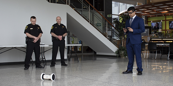 Avishek Paul, a member of the Reconnaissance Robot senior design team, demonstrates the robot's capabilities for members of the Tioga County Sheriff's Department.