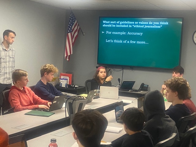 Philosophy, politics and law major Trevor Fornara and political science major Amanda Escotto lead a discussion about political science writing at Chenango Valley High School.
