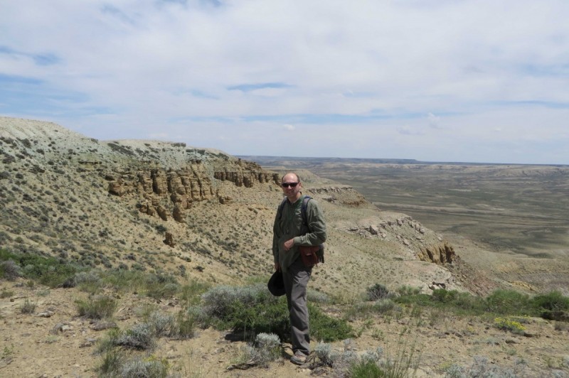 Associate Professor of Geological Sciences Jeffrey Pietras at the top of a section of the Green River Basin in Wyoming.