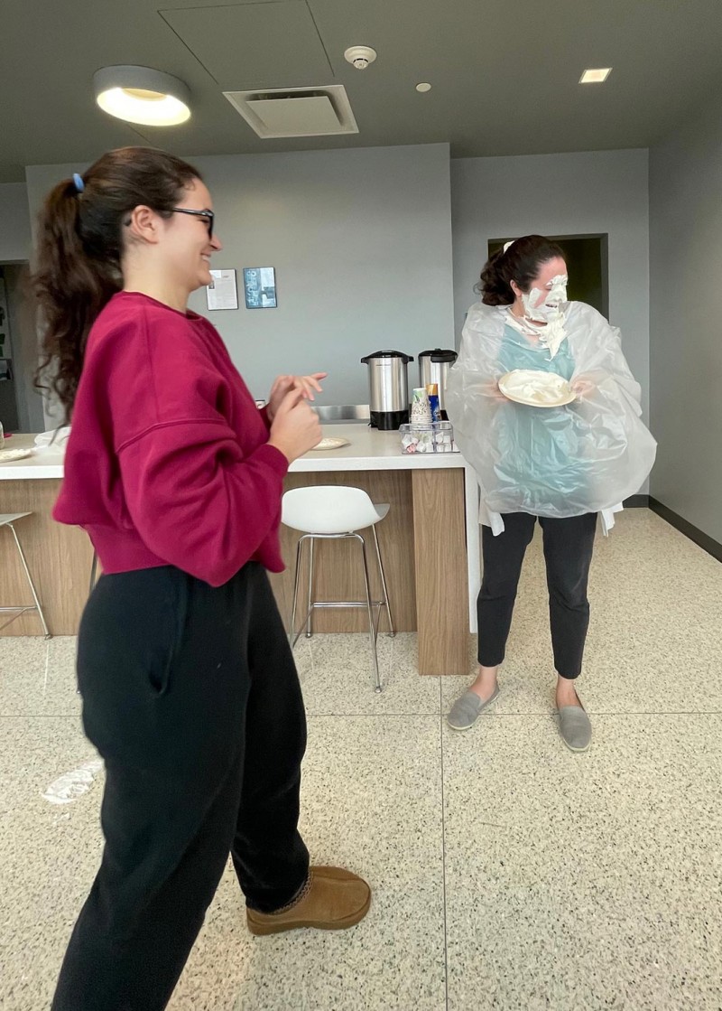 Second-year pharmacy student Sophia Czabala laughing at the aftermath of pieing Instructional Support Associate Katie Sasina.