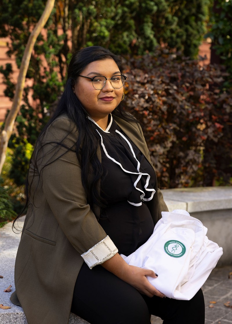 Lamiyah Kamal, PharmD '21 with her School of Pharmacy and Pharmaceutical Sciences white coat.
