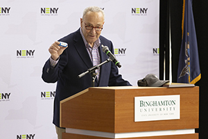 U.S. Senate Majority Leader Chuck Schumer displays a lithium-ion battery at the Jan. 29 NSF Engines announcement. Schumer received an autographed battery from Nobel Laureate M. Stanley Whittingham.