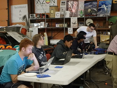 John Null assists a student attending the game creation class.