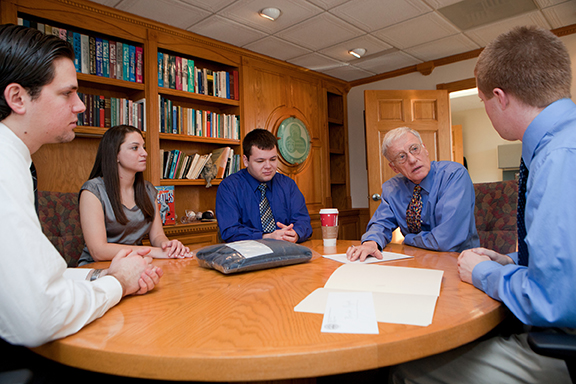 C. Peter Magrath, then-president of Binghamton University, meets with members of the Harpur's Ferry Medical Unit in December 2011. Magrath signed the original paperwork that started Harpur's Ferry during his first term as president in 1973.