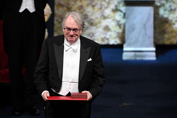 Binghamton University Distinguished Professor M. Stanley Whittingham bows to the audience after receiving the Nobel Prize in Chemistry from King Gustaf of Sweden at the Stockholm Concert Hall Dec. 10.