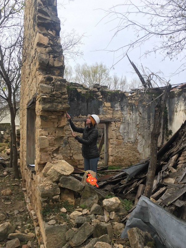 Graduate student Patricia Markert investigates a structure in Castroville, Texas.