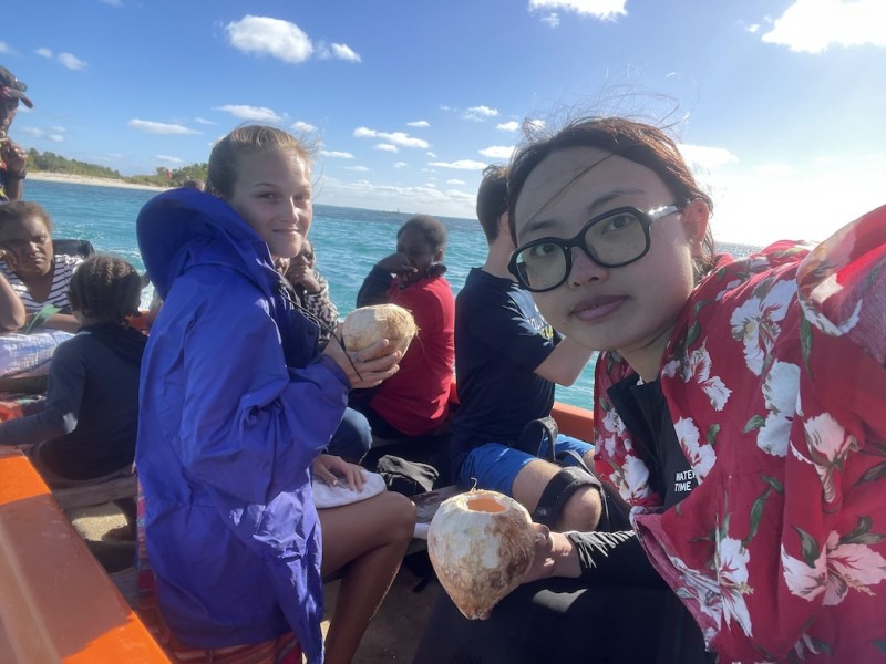 Students Zhiqiao Huang and Olivia LaSalle enjoy coconuts and a boat ride off the coast of Vanuatu.