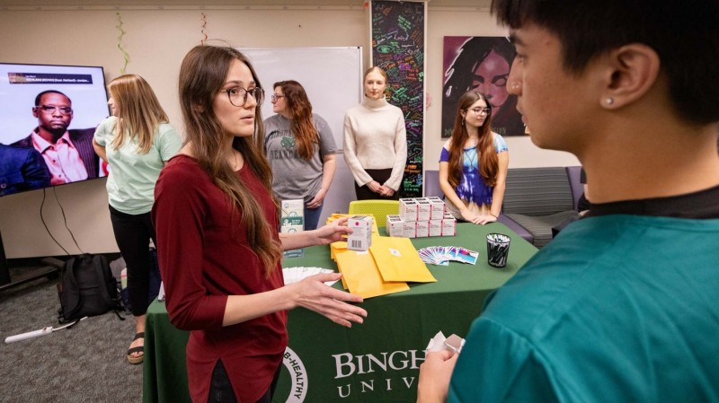 Third-year Pharmacy student Victoria Kostiv talks with a Binghamton University student during a drug take-back and Narcan training event held in the Multi-cultural Resource Center on campus.