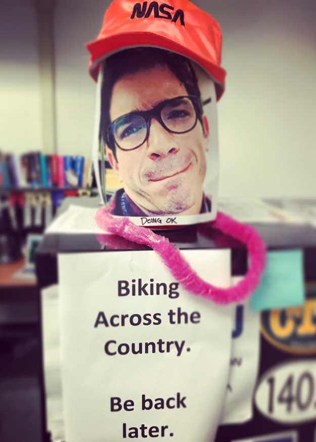 James Warner’s co-workers created a “stand-in” for him while he was on his crosscountry bike trip. One side says he’s “doing OK.” The opposite side has a more-serious photo of him and says “concerned.” His officemate chose which photo to show based on how Warner was doing on his trip.