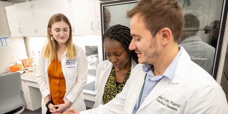 Clinical Associate Professor Wesley Kufel examines microbiologic cell cultures to help determine appropriate antibiotic selection for a patient with an infection.