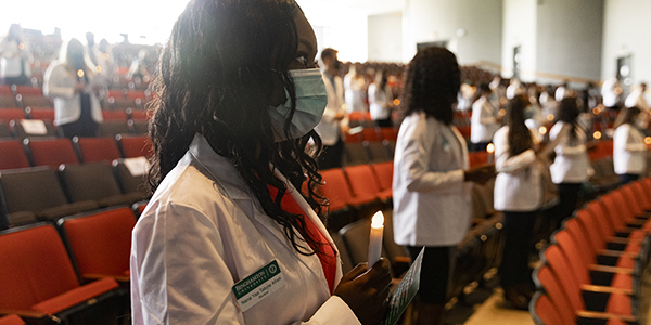 Nana Ya Afreh and more than 40 other incoming Doctor of Pharmacy students recite the Oath of a Pharmacist in the first of two socially distanced White Coat ceremonies held in the Anderson Center's Osterhout Concert Theater Aug. 29.