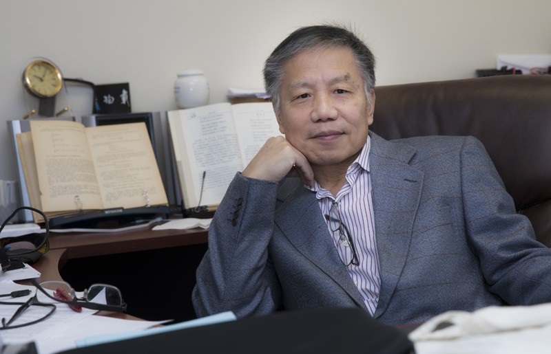 Zili Yang, an economics professor at Binghamton University, is seen in his office in the Library Tower.