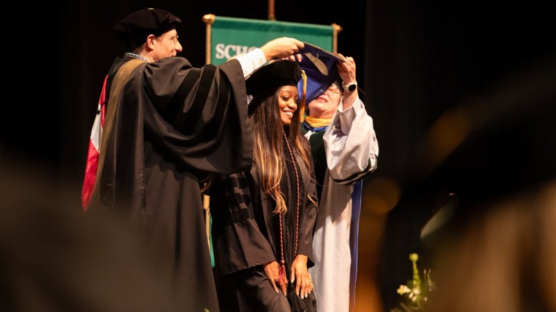 Doctor of Pharmacy graduate Ashanté Concepcion is hooded by Associate Professor Aaron Beedle and Clinical Professor Kenneth 