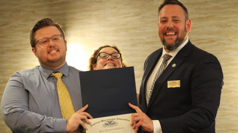 P4 student Ashton McCormack (left) accepts the Senior Recognition Award from the Administrative Coordinator of Student Affairs Amanda Padwa (middle) and the Director of Student Affairs James 